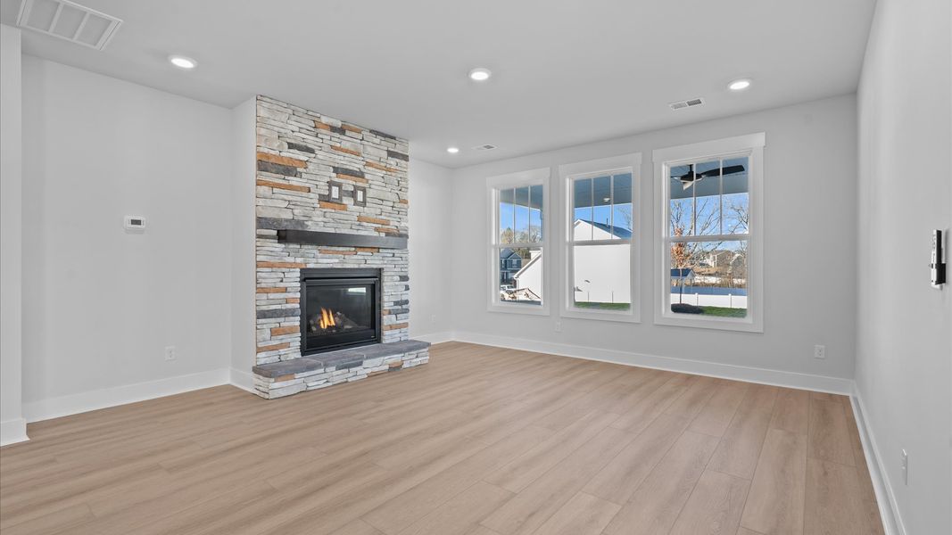 Memorable moments begin in this elegant, open family room with hardwood flooring and refined finishes