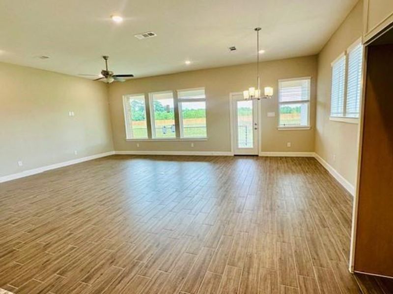 Open Living and Dining area with a wall of windows overlooking patio and reserve!