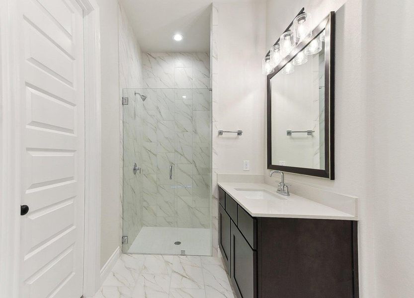 Full bath featuring a marble finish shower, recessed lighting, marble finish floor, and vanity Full bath featuring a marble finish shower, recessed lighting, marble finish floor, and vanity