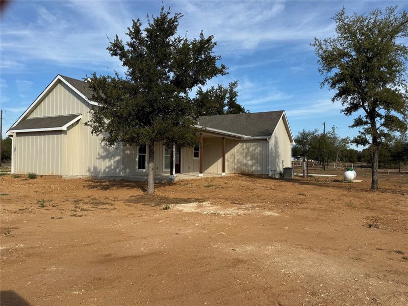 View of home's exterior featuring a shingled roof View of home's exterior featuring a shingled roof