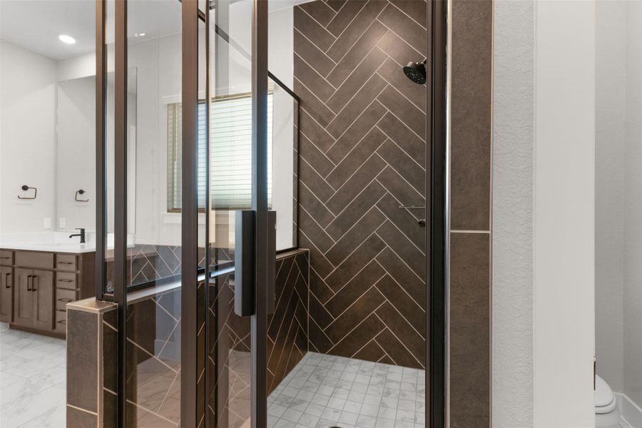 Bathroom with a stall shower and vanity