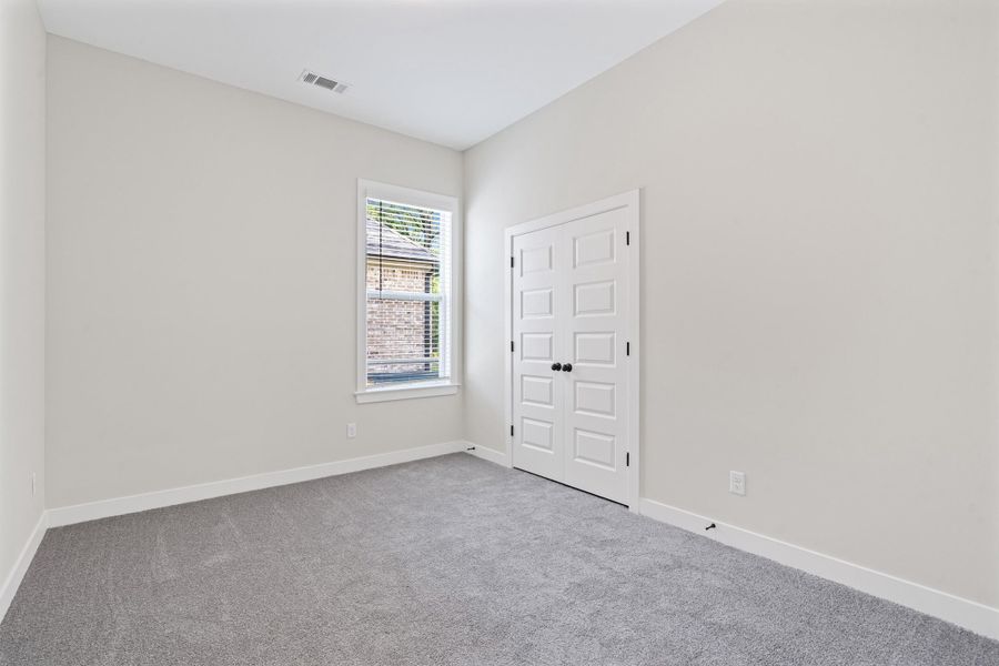 Carpeted spare room with baseboards Carpeted spare room with baseboards
