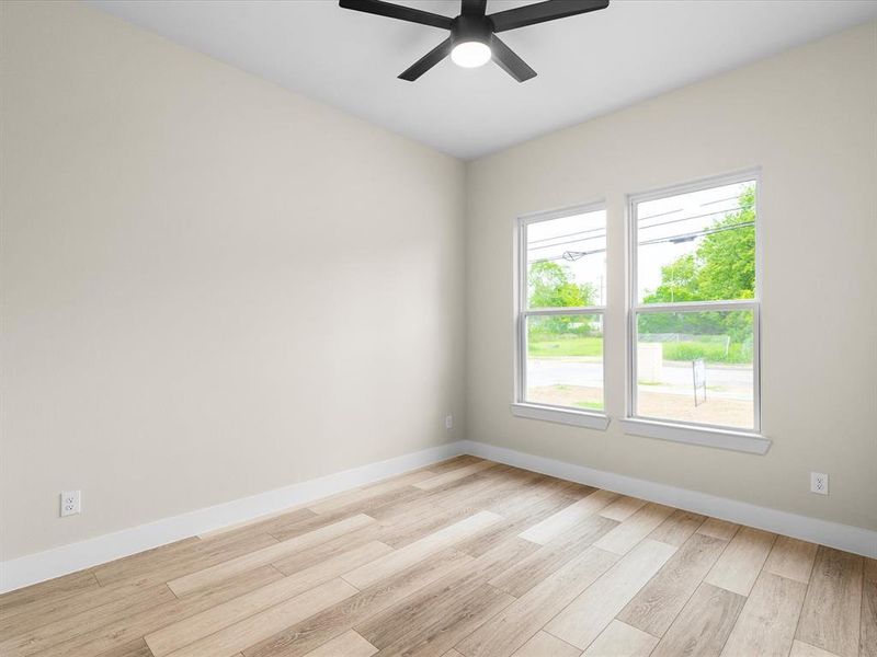 Unfurnished room with light wood finished floors and a ceiling fan