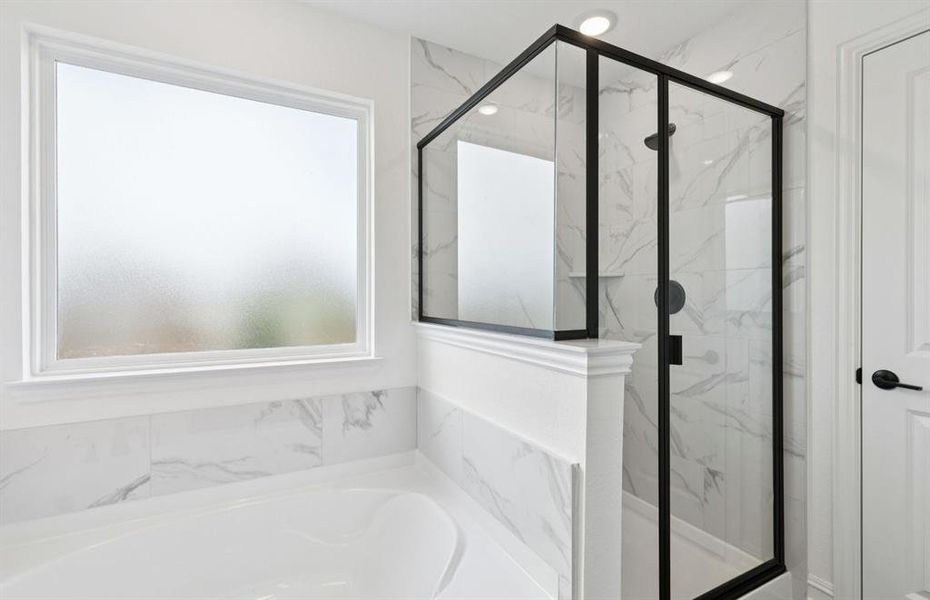 Deep walk-in shower designed for relaxation in the owner's bath   *Real home pictured