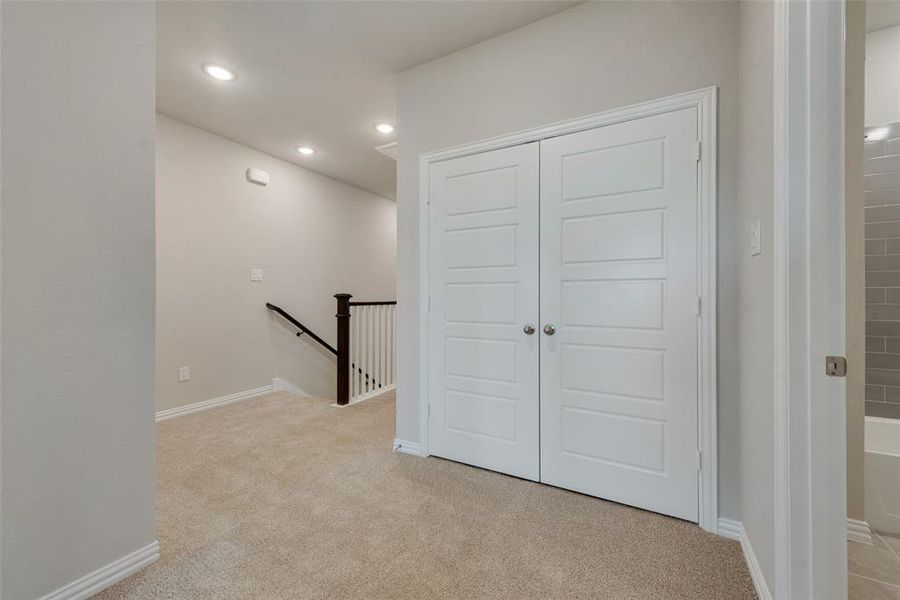 Hall with light colored carpet