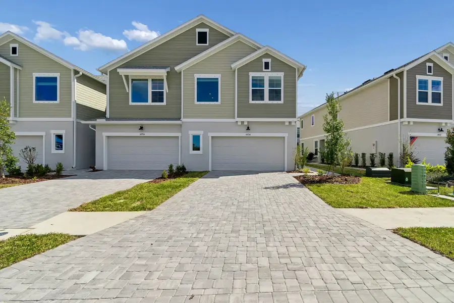 Front exterior of a new home in North River Ranch – Townhomes, Parrish, FL, highlighting curb appeal (Image 1). Front exterior of a new home in North River Ranch – Townhomes, Parrish, FL, highlighting curb appeal (Image 1).