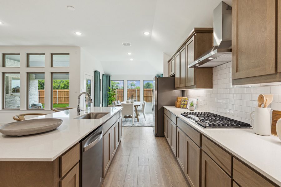 Kitchen in the Gilmour home plan by Trophy Signature Homes – REPRESENTATIVE PHOTO