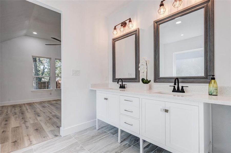 Bathroom with vanity, hardwood / wood-style flooring, lofted ceiling, and ceiling fan