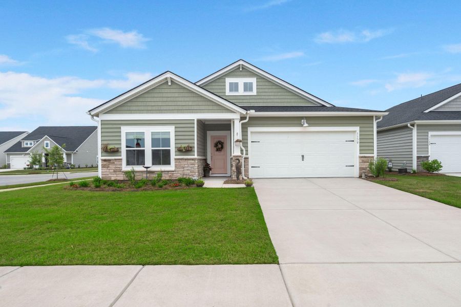 Front exterior of a new home in Horizons at Summers Corner | 55+: The Legends, Summerville, SC, highlighting curb appeal (Image 26).