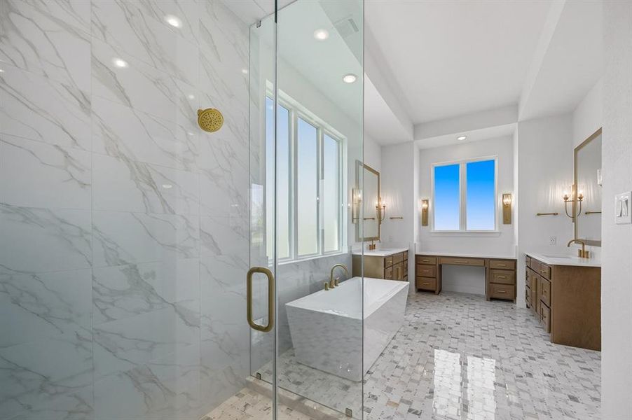 Full bathroom with a marble finish shower, a freestanding bath, two vanities, and recessed lighting Full bathroom with a marble finish shower, a freestanding bath, two vanities, and recessed lighting