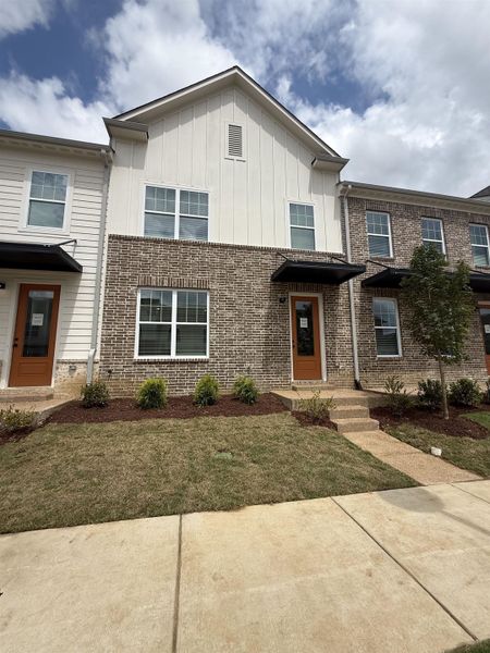 Contemporary townhome facade featuring brick and vertical siding Contemporary townhome facade featuring brick and vertical siding