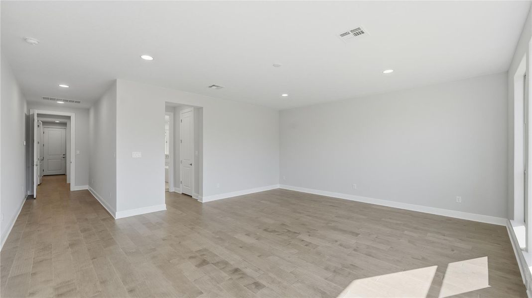 Empty room with recessed lighting and light wood-style flooring Empty room with recessed lighting and light wood-style flooring