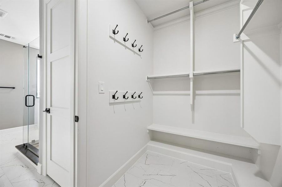 Mudroom with light marble finish floors and baseboards Mudroom with light marble finish floors and baseboards