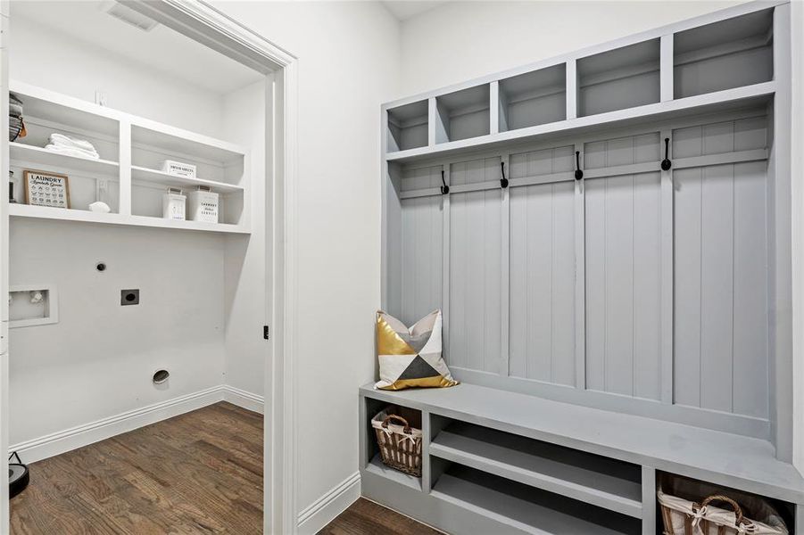 Mudroom with dark wood-type flooring and baseboards