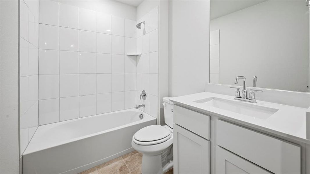 Modern bathroom featuring a white vanity with an integrated sink, polished chrome faucet, and expansive wall mirror