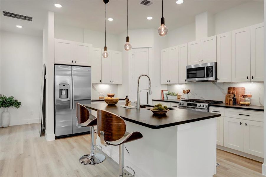 The kitchen has solid wood cabinets, walk-in pantry, and marble backsplash.