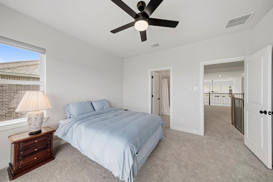 A private ensuite bath enhances this bedroom with added comfort and convenience, creating a well-appointed retreat for family members or overnight guests.