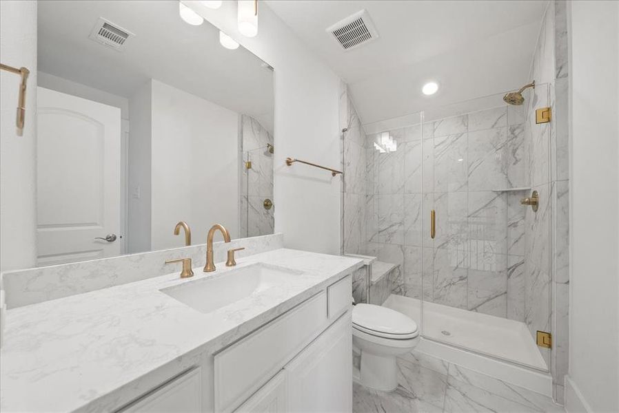 Bathroom featuring vanity, light marble finish floors, a marble finish shower, and recessed lighting Bathroom featuring vanity, light marble finish floors, a marble finish shower, and recessed lighting