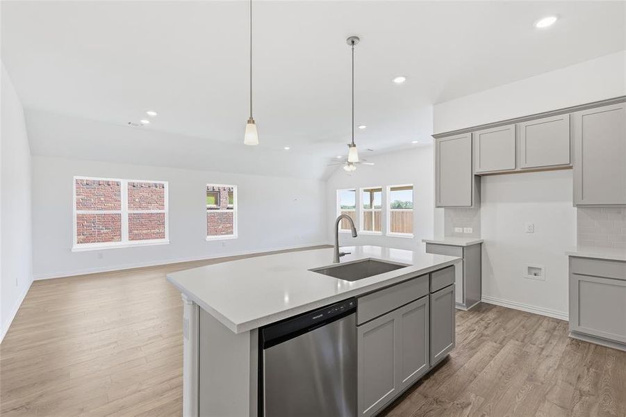Kitchen island with an undermount sink, gooseneck faucet, and integrated dishwasher