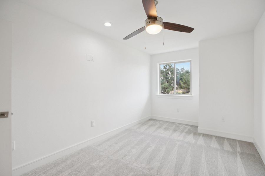 Spare room with light colored carpet, ceiling fan, and recessed lighting