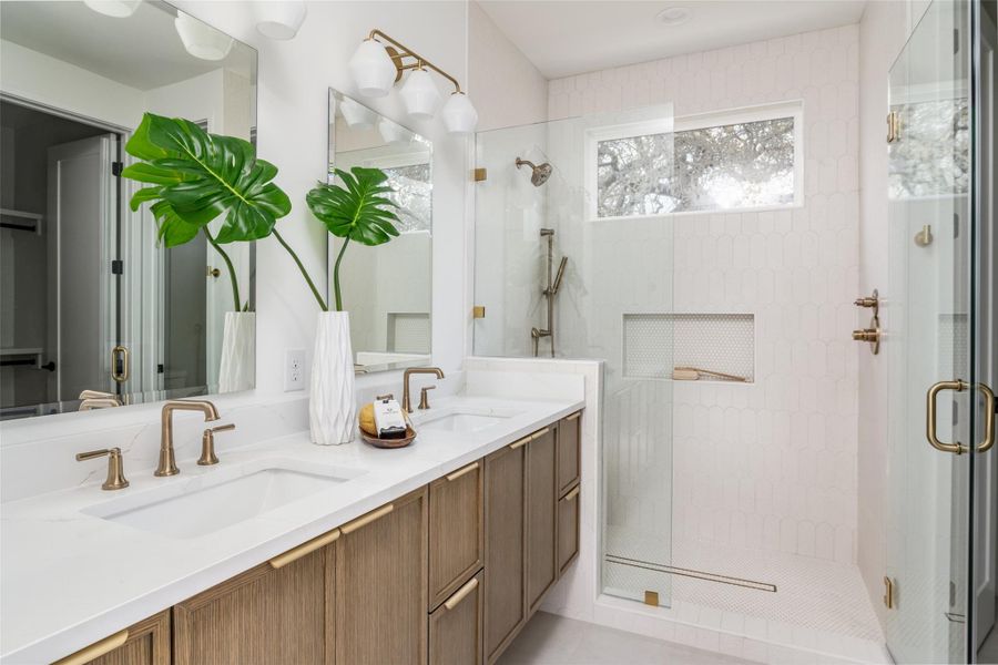 Primary Bathroom featuring double vanity, walk in shower