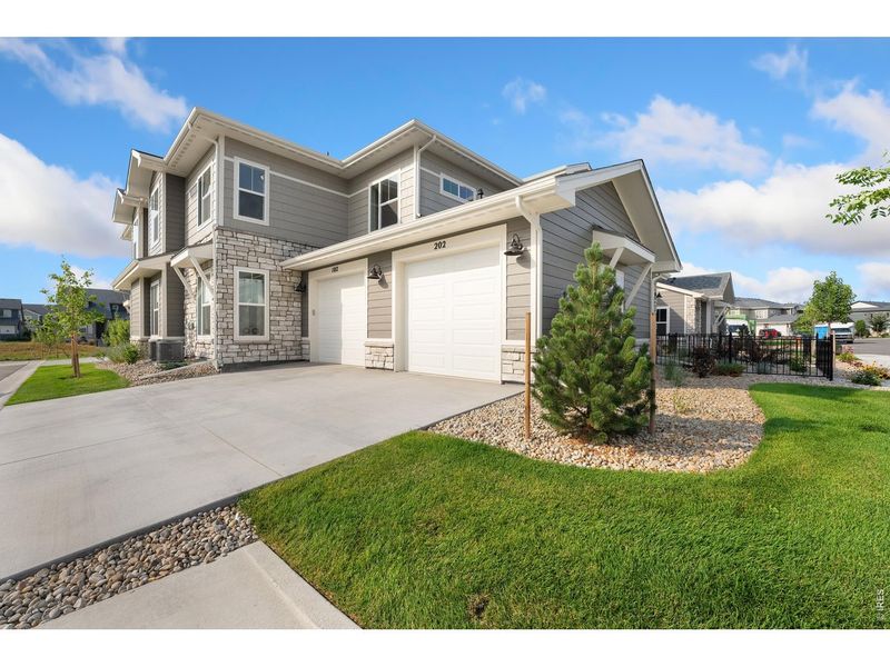 Front exterior of a new home in The Lakes at Centerra - Discovery, Loveland, CO, highlighting curb appeal (Image 16).
