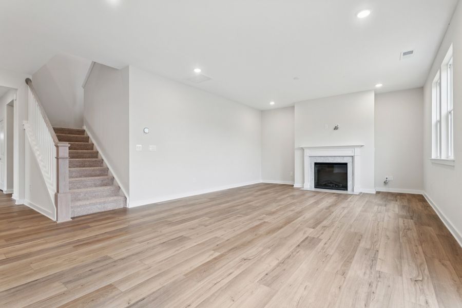 A large empty room with a fireplace.