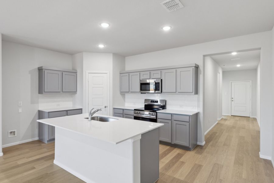 Kitchen in the Holden home plan by Trophy Signature Homes – REPRESENTATIVE PHOTO