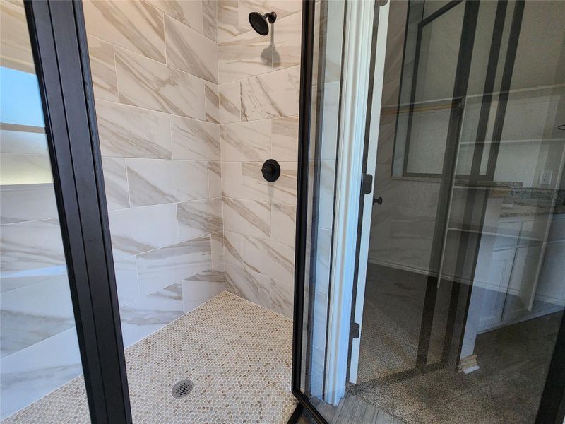 Full bathroom featuring a shower stall