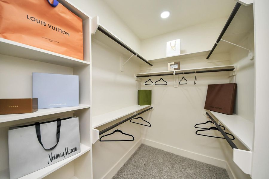 Expansive walk-in closet with built-in shelving and massive storage potential.