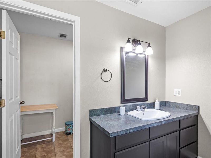 Bathroom featuring vanity and tile patterned floors Bathroom featuring vanity and tile patterned floors