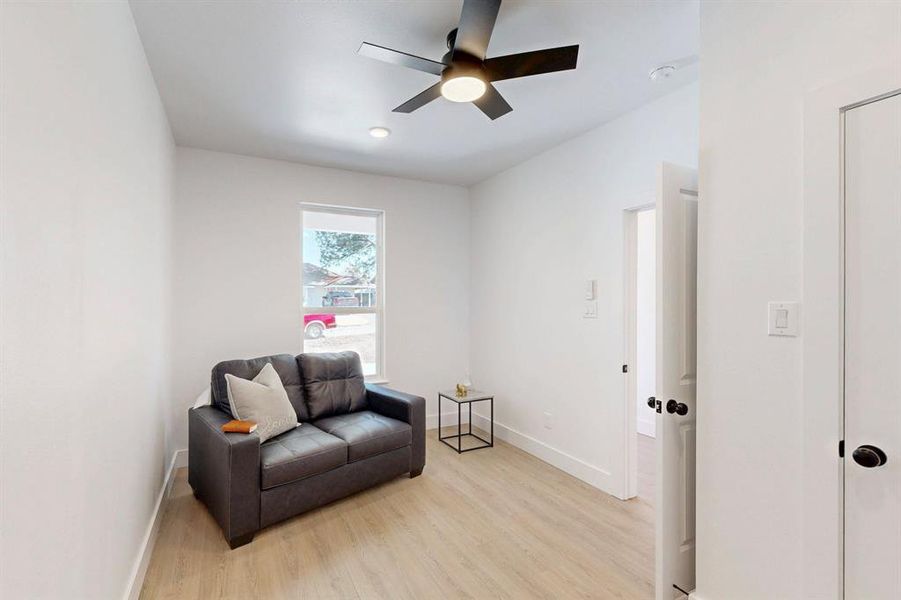 Sitting room featuring ceiling fan and light hardwood / wood-style flooring