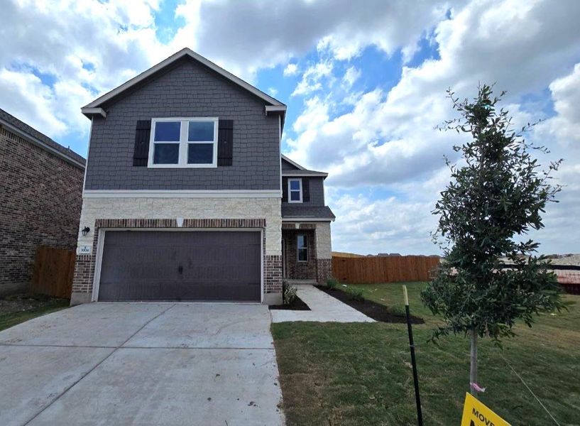 Front exterior of a new home in Salerno - Heritage Collection, Round Rock, TX, highlighting curb appeal (Image 19). Front exterior of a new home in Salerno - Heritage Collection, Round Rock, TX, highlighting curb appeal (Image 19).