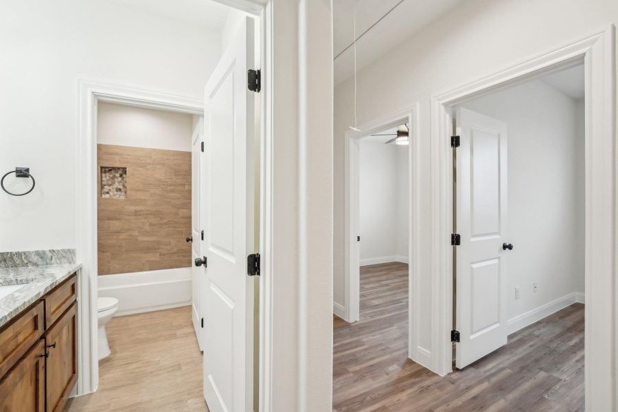Full bathroom featuring visible vents, toilet, shower / bathing tub combination, and vanity Full bathroom featuring visible vents, toilet, shower / bathing tub combination, and vanity