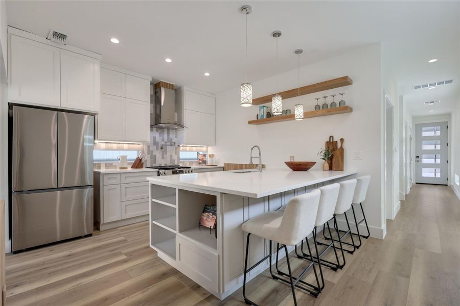 Eat-In-Kitchen: Custom cabinetry with extensive storage solutions, custom wood accents, stainless appliances, and Quartz counters. Eat-In-Kitchen: Custom cabinetry with extensive storage solutions, custom wood accents, stainless appliances, and Quartz counters.