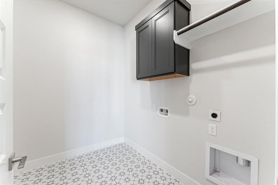 Utility Room with Washer and Dryer Connections, Hanging Bar, and Storage Cabinet.