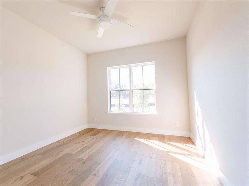 Unfurnished room with light wood-type flooring and ceiling fan