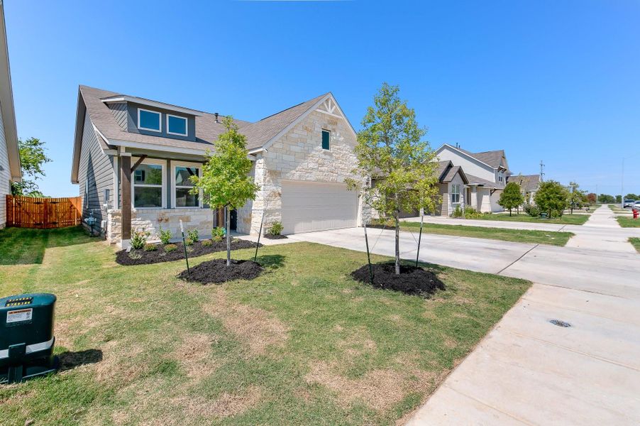 Front exterior of a new home in Cottonwood Farms, Hutto, TX, highlighting curb appeal (Image 22). Front exterior of a new home in Cottonwood Farms, Hutto, TX, highlighting curb appeal (Image 22).