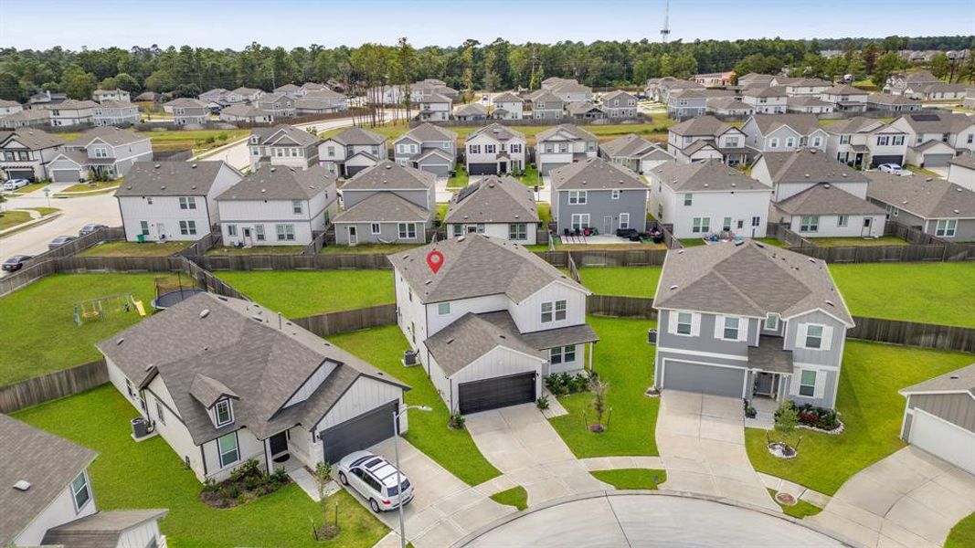 An additional aerial view showcasing the home's oversized cul-de-sac lot with luscious landscaping and double-wide driveway.