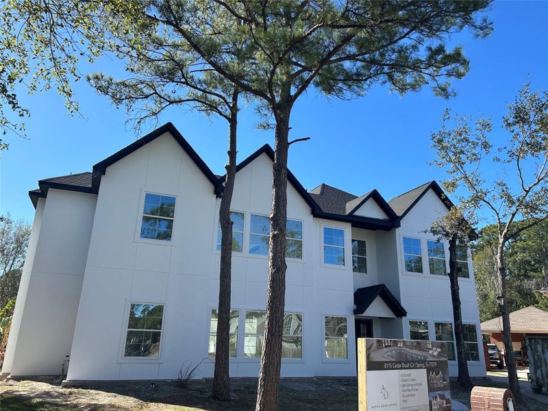 Front exterior of a new home in , Spring, TX, highlighting curb appeal (Image 7).