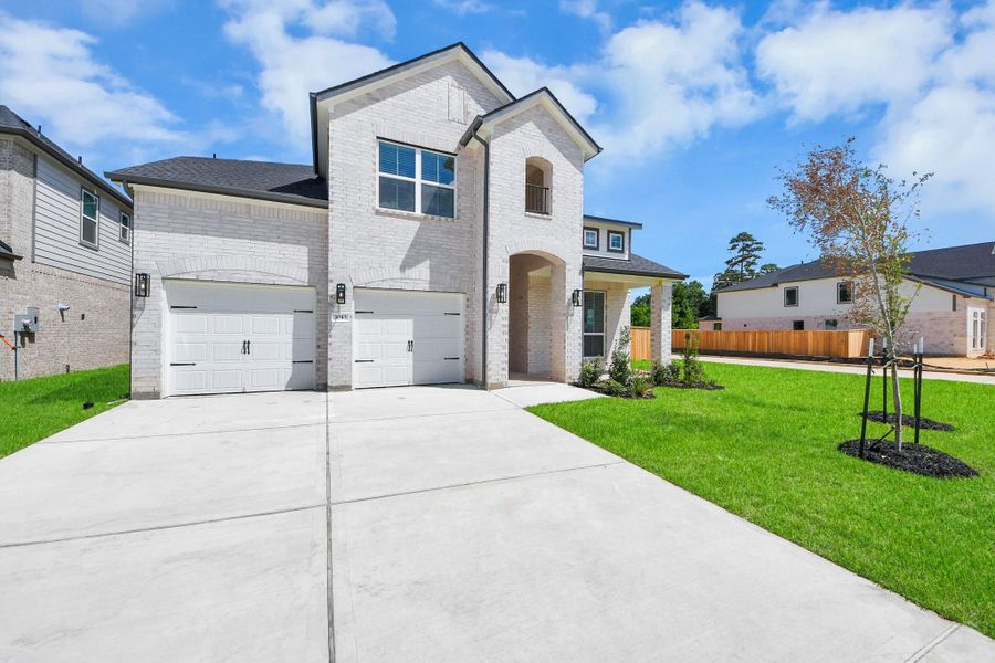This home boasts lush green grass and meticulous landscaping. Its premium elevation showcases an exquisite blend of brick and stone features, complemented by modern coach lighting. This home boasts lush green grass and meticulous landscaping. Its premium elevation showcases an exquisite blend of brick and stone features, complemented by modern coach lighting.