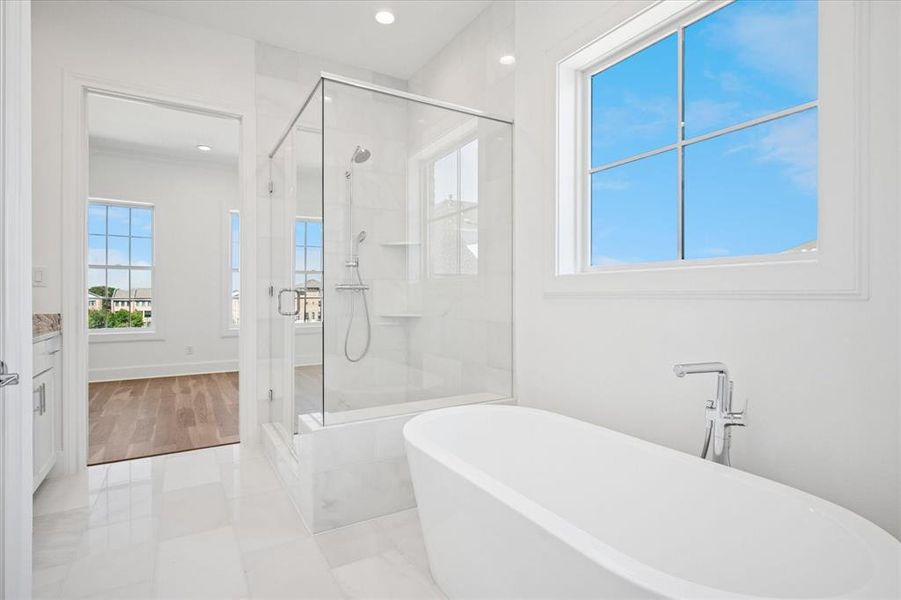Full bath featuring a soaking tub, a shower stall, vanity, recessed lighting, and light tile patterned floors Full bath featuring a soaking tub, a shower stall, vanity, recessed lighting, and light tile patterned floors