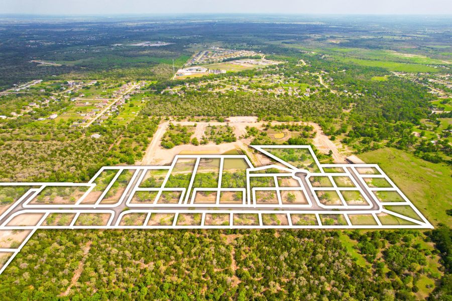 An aerial perspective reveals a developing neighborhood with plots outlined, surrounded by expansive green landscapes.