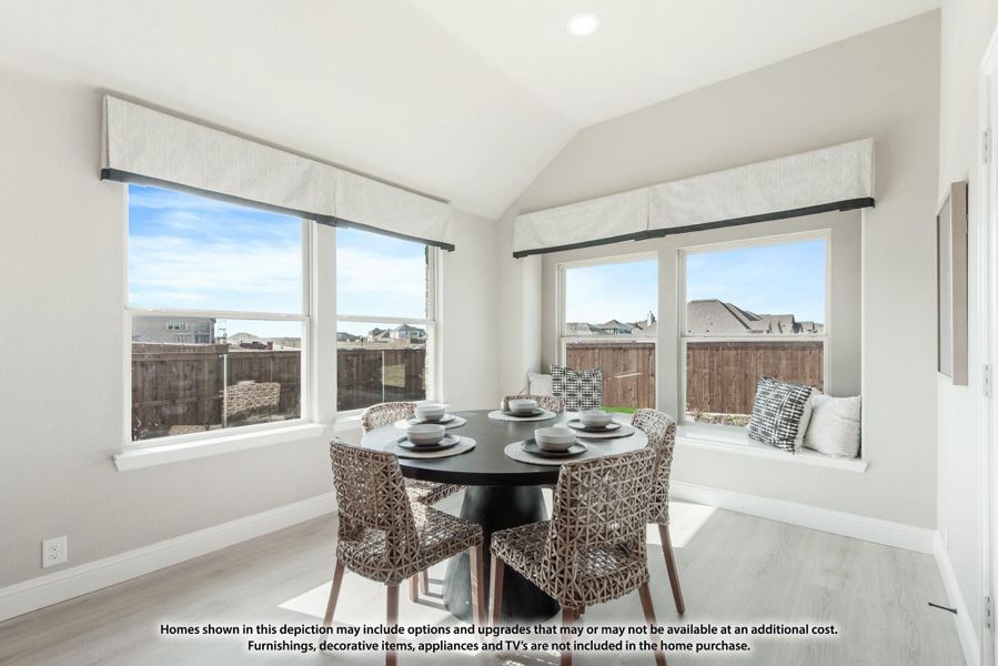 Bright dining nook with round dark table, four woven chairs, window seat, and large windows with neighborhood views Bright dining nook with round dark table, four woven chairs, window seat, and large windows with neighborhood views