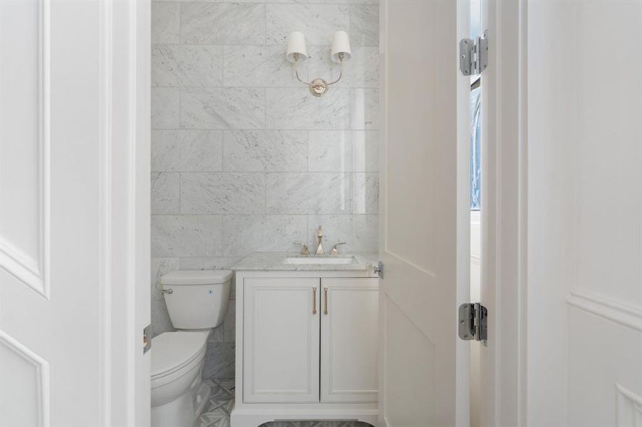 Tucked away on a private landing down the staircase, the second floor half bath features gorgeous finishings and privacy. (photo of interior model home with smaller floor plan)