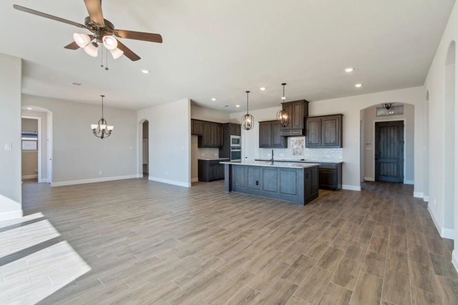 Family Room & Kitchen | Concept 2586 at Hidden Creek Estates in Van Alstyne, TX by Landsea Homes