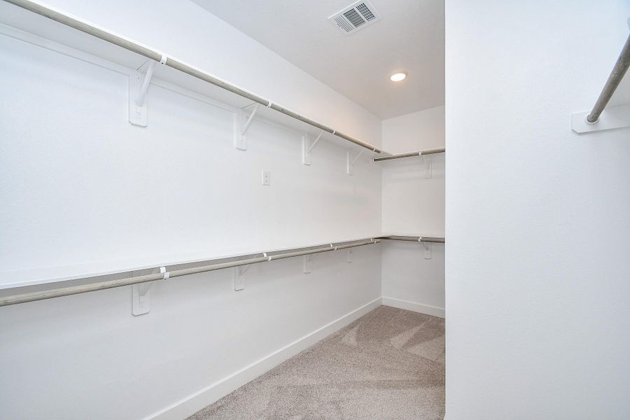 A massive walk-in closet with built-in shelving and ample storage for any wardrobe.