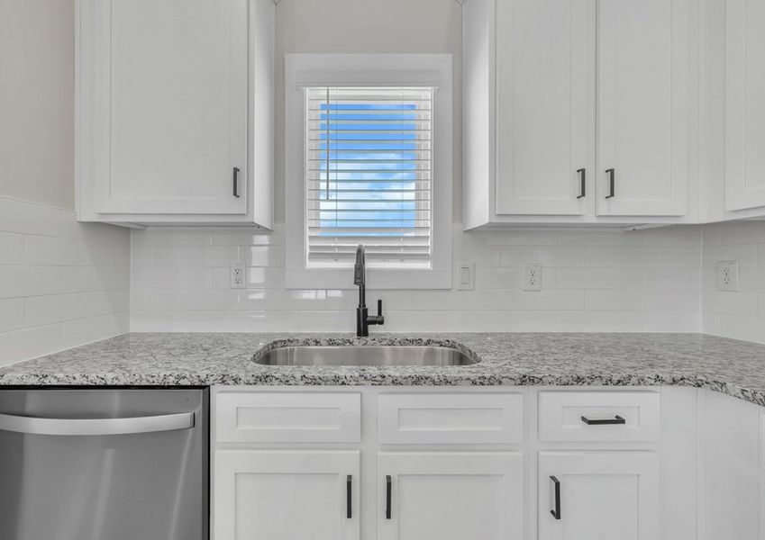The kitchen has a bright backsplash.