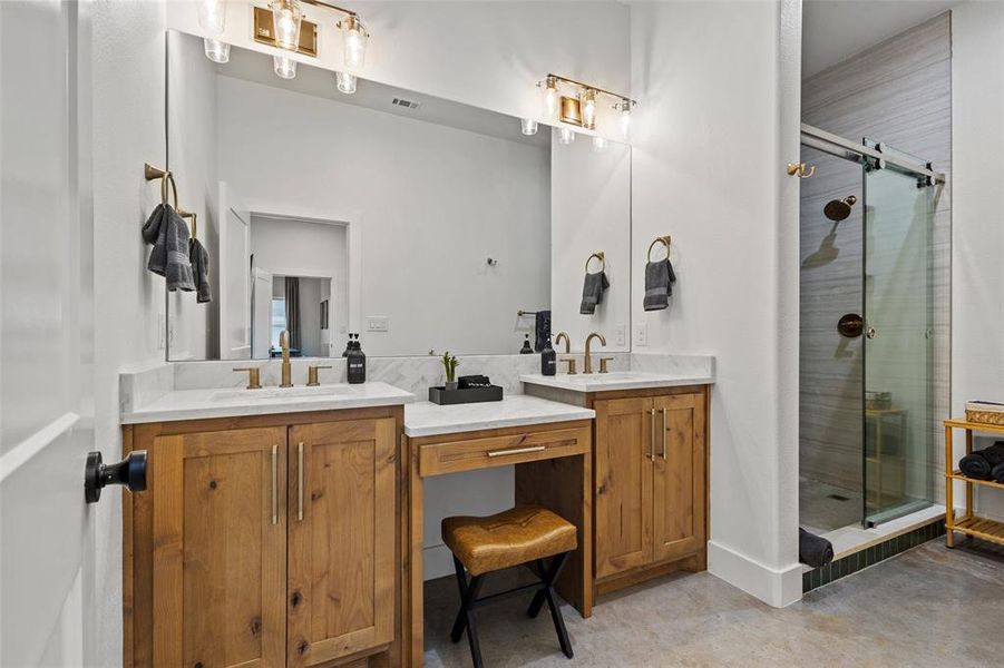 Full bath featuring double vanity and a stall shower