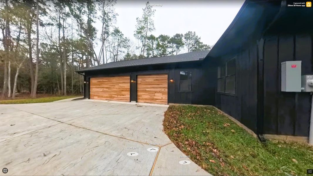 Oversized 3 Car Garage with Wood Accents on the Doors.